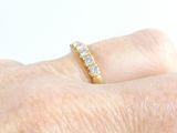 a woman ' s hand with a diamond ring on it