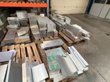 several pallets of metal are stacked on pallets in a warehouse