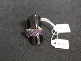 a silver ring with purple stones on it and a price tag