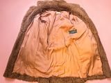 an image of a tan jacket with a fur collar on a pink background