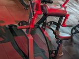 a row of exercise bikes in a gym with red lights