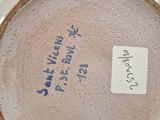 a close up of a vase with a tag on it