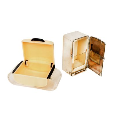 two open suitcases sitting next to each other on a white surface