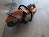 an image of a small orange motorcycle parked in a garage