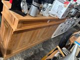 a wooden counter with a coffee maker on top of it