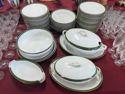 many plates and bowls on a table with wine glasses