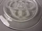 a glass plate with a figurine of a woman on it