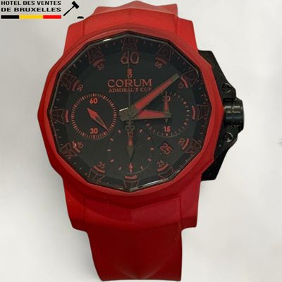 the watch is red and has black dials on it