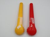two yellow and red plastic baseball bats on a white surface