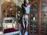 a statue of a man on a pedestal in a room