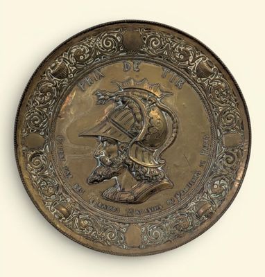 a gold plate with a picture of a man on a horse on it
