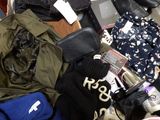 a pile of clothes and other items on the floor