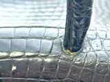 a close up of a silver purse with a handle