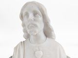 marble bust of a man with long hair wearing a white shirt