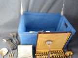 silverware and silverware in a blue box on a table