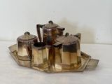a silver tray with a silver tea set on it