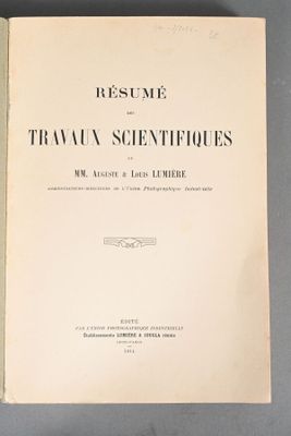 an open book with a black and white cover sitting on top of a table