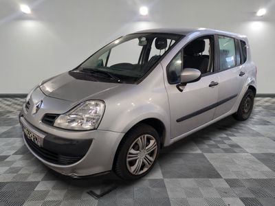 a picture of a small silver car parked in a garage