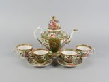 an image of a tea set with four cups and saucers