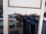 a mirror that is sitting on a table in a room