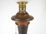a lamp that is sitting on a table next to a white wall