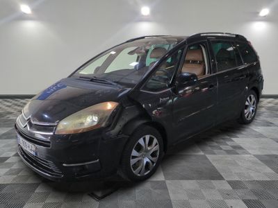 a picture of a small black car parked in a garage