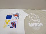 two t - shirts that are sitting on a table