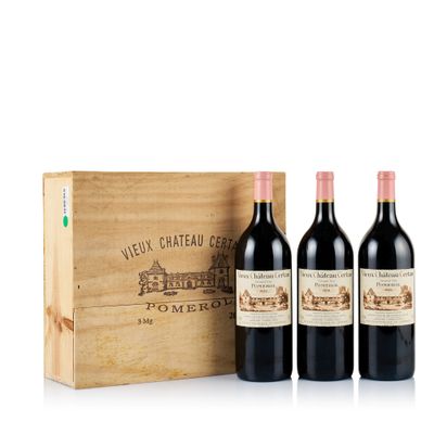 three bottles of wine in front of a wooden box