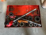 a red tool box with a wren and some other tools in it