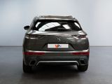 the rear end of a grey suv parked in a room
