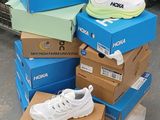 several boxes stacked on top of each other with a pair of sneakers on them