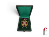 an image of a medal in a green case on a white background