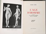 an open book with a picture of two nudes on it