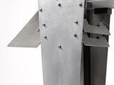 a metal object that is on a white surface