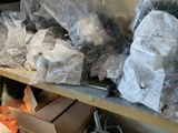 many bags of items on a shelf in a room