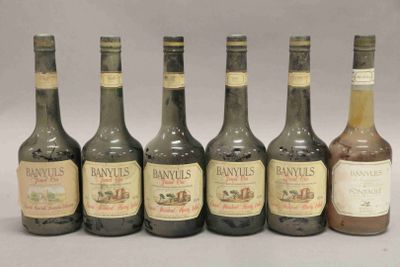 six bouteilles de vin sont alignées sur une table