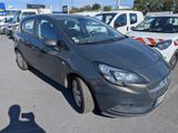 a grey car parked in a parking lot with other cars