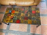 a coffee table that has a clock on top of it