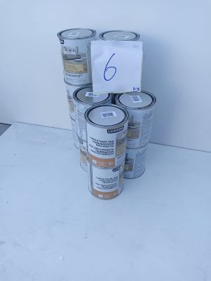 several cans of paint are stacked on top of each other