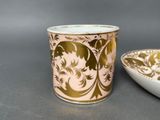 a cup that is sitting on a table next to a bowl
