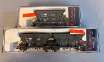 two train cars sitting side by side on a table