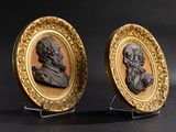 pair of carved and gilded portrait plaques of two men