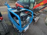 a small tractor that is parked on the side of the road