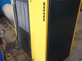 a yellow and black air compressor in a warehouse