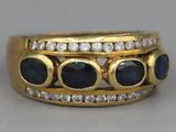 an image of a gold ring with sapphires and diamonds