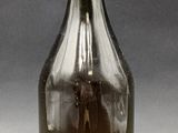 an image of a brown glass bottle with a gold cap