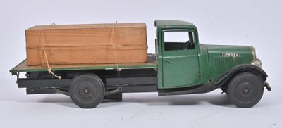 a green truck with a wooden box on the back of it