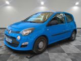 the small blue car is parked in a room with a checkered floor