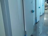 a long hallway with a bunch of doors in it