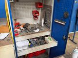 a blue cabinet with tools inside of it in a garage
